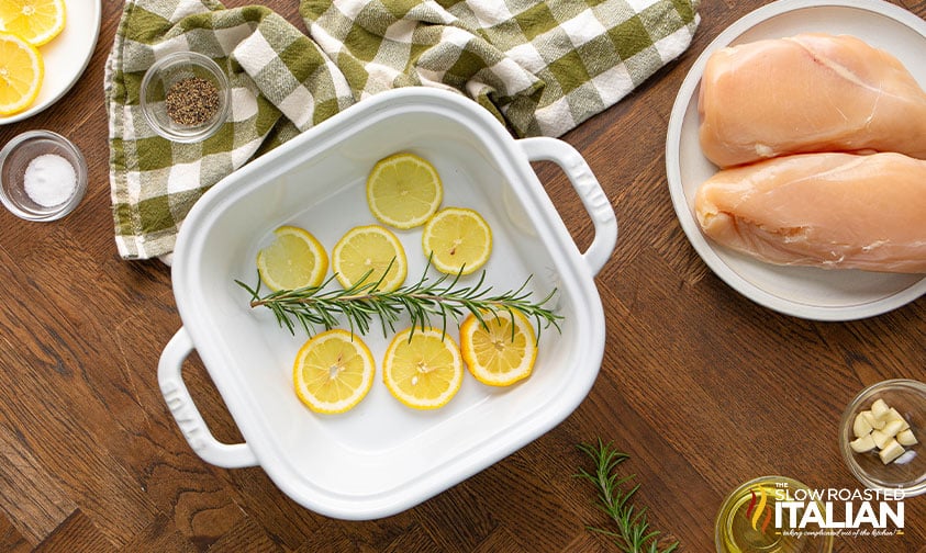 lemon slices and rosemary in baking dish