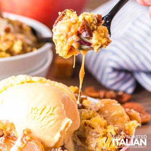 closeup of caramel apple dump cake with a scoop of ice cream