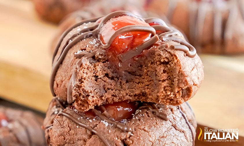 closeup of stacked chocolate cherry thumbprint cookies