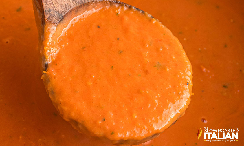 copycat panera soup being served with a wooden spoon