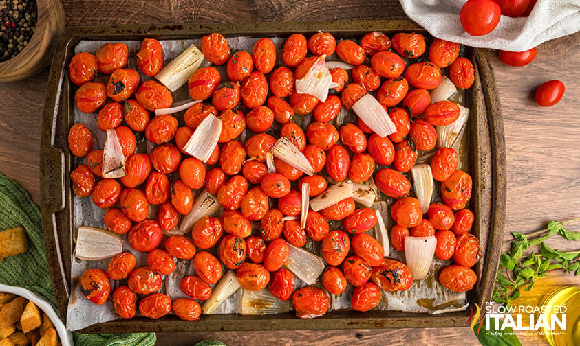 roasted tomatoes and shallots on a baking sheet
