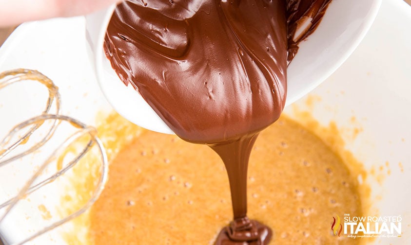 adding chocolate to mixing bowl