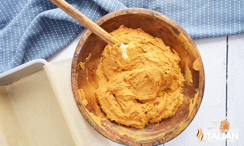 pumpkin puree and flour mixing in a wooden bowl