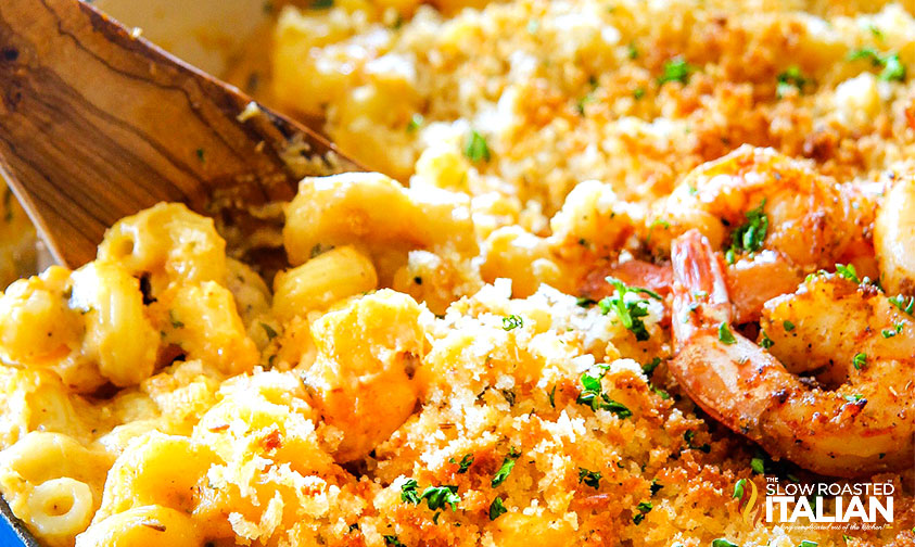 serving shrimp mac and cheese with wooden spoon