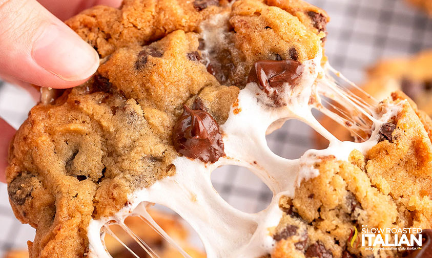 hand breaking smookies cookie with melted marshmallow