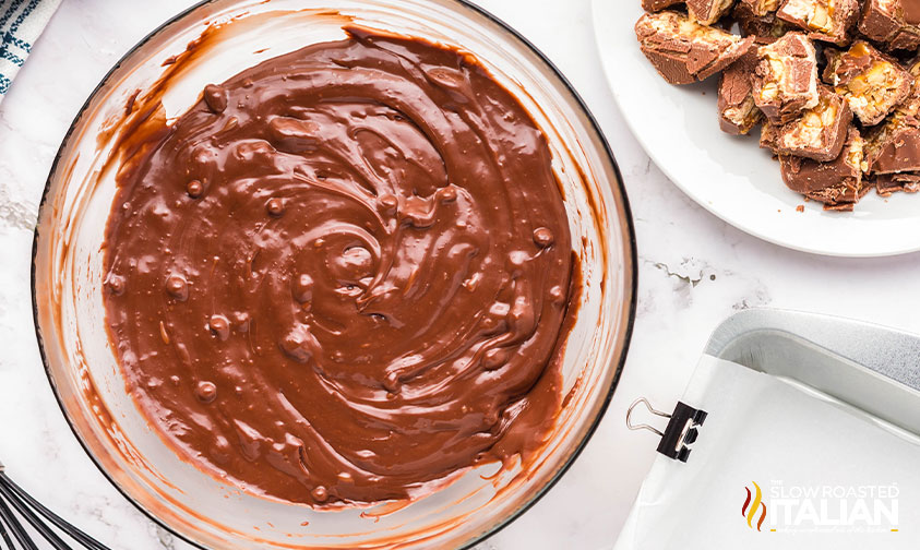 melted chocolate and sweetened condensed milk in glass bowl