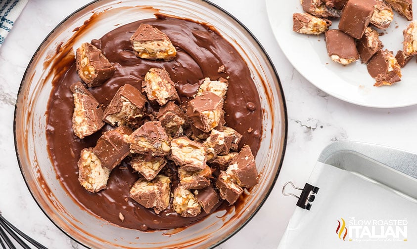 adding chopped snickers bars to chocolate fudge