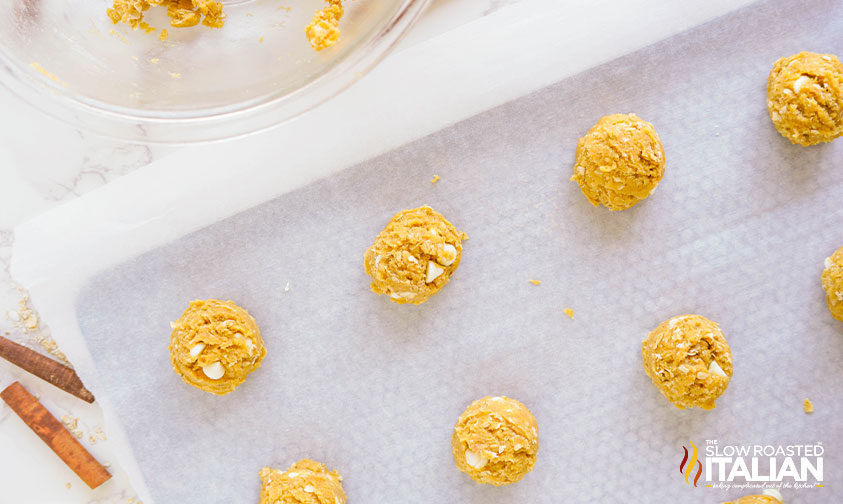 scoops of cookie dough on parchment lined baking sheet