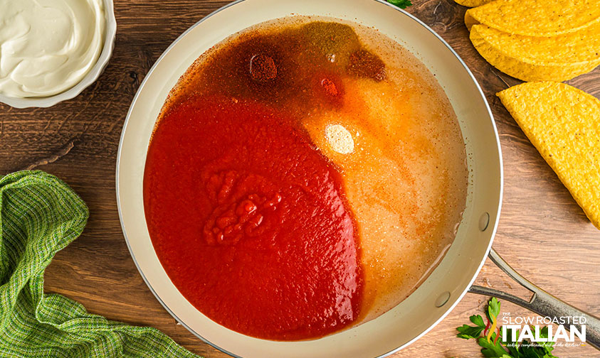 tomato sauce spices and water in a skillet