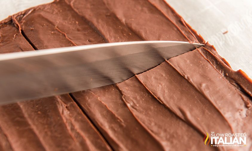 slicing homemade fudge into squares