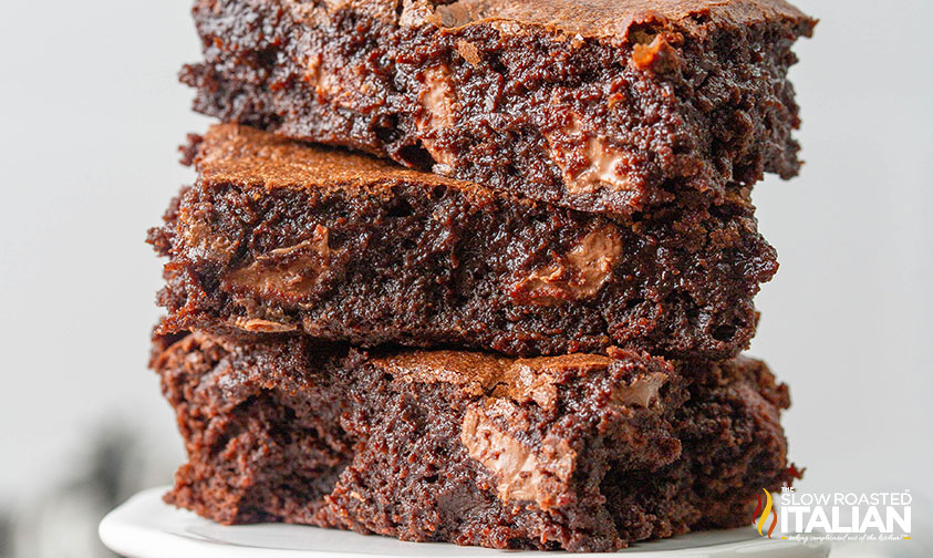 closeup of 3 stacked fudgy cocoa brownies