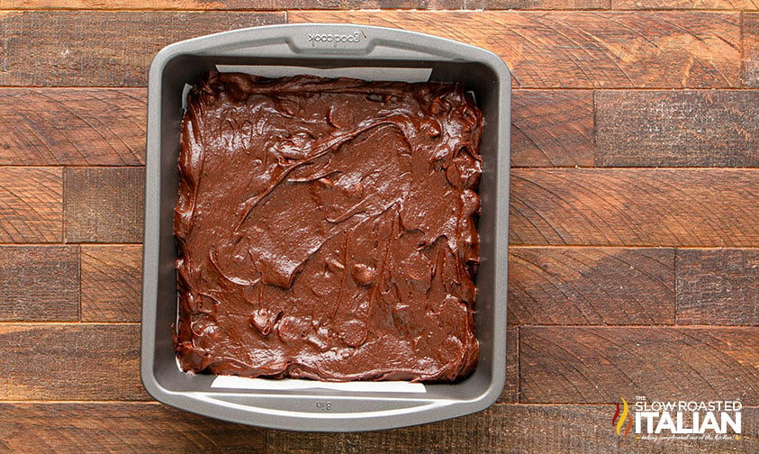 brownie batter in parchment lined baking pan