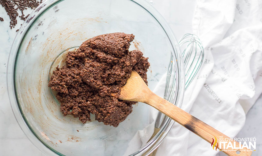 adding rum, honey and water to dry mixture for boozy rum balls