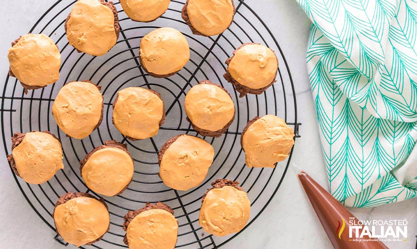 peanut butter mix on top of cookies on cooling rack