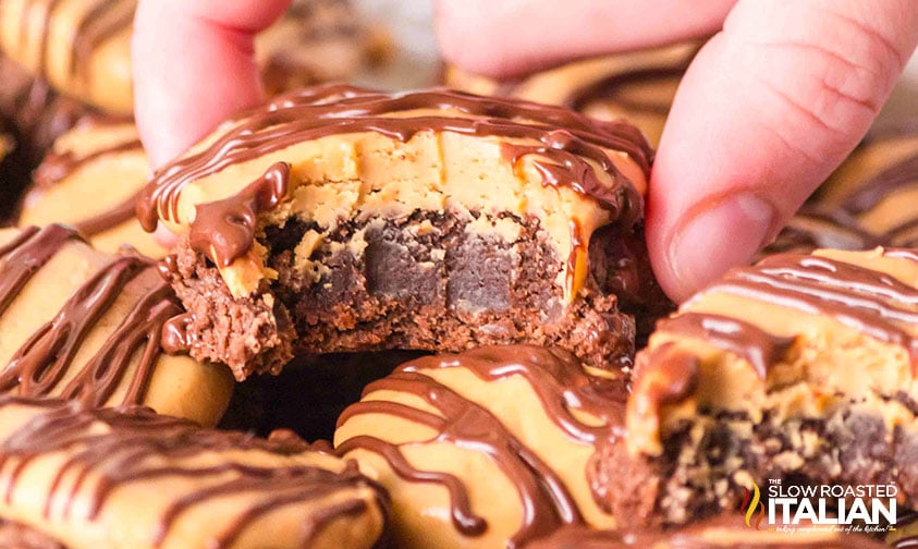 fingers holding a buckeye brownie cookie