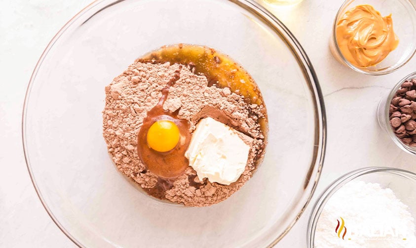 mixing ingredients for copycat crumbl buckeye brownie cookies