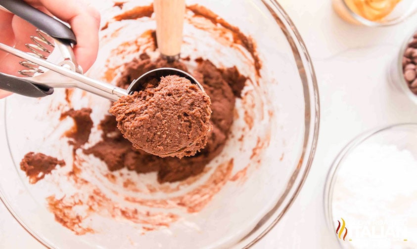 scooping cookie dough from mixing bowl