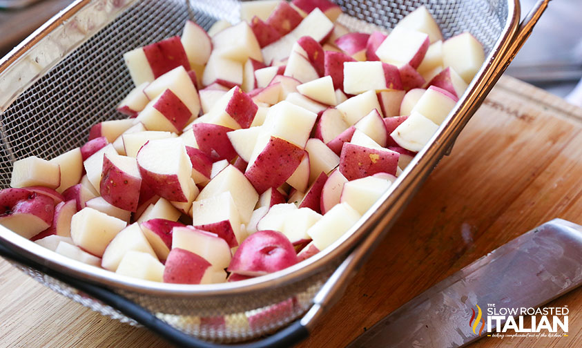 sliced potatoes in a strainer