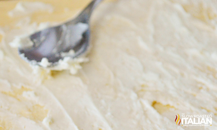 adding peppermint white chocolate icing to crescent dough