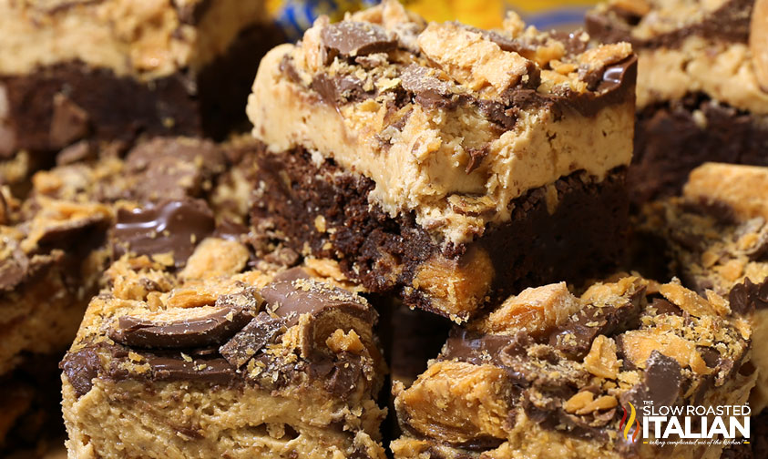 closeup of stacked loaded brownies with butterfingers