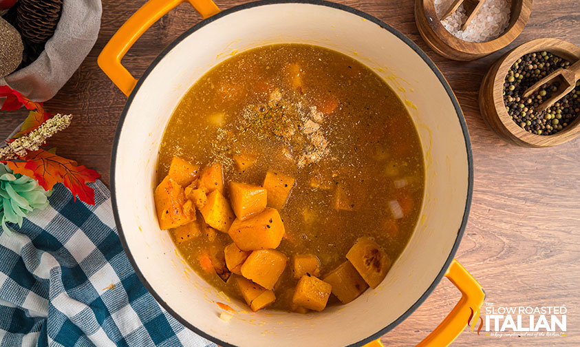 adding squash, vegetable broth, and seasonings to pot