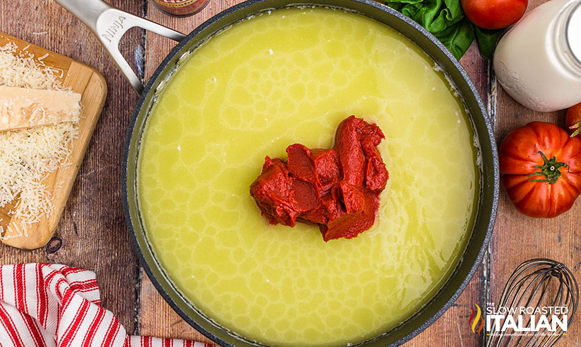 adding tomato paste to pan for penne alla vodka