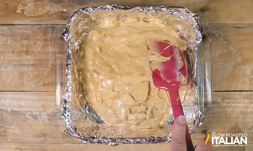 adding fudge to a baking dish