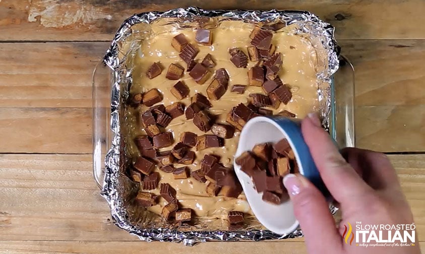 adding chopped reese's to peanut butter fudge