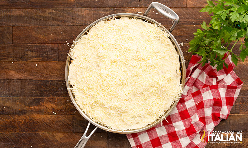 adding mashed potatoes and cheese to skillet