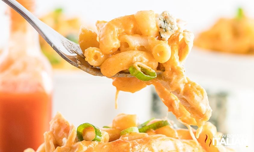 closeup: forkful of spicy chicken mac and cheese with green onions