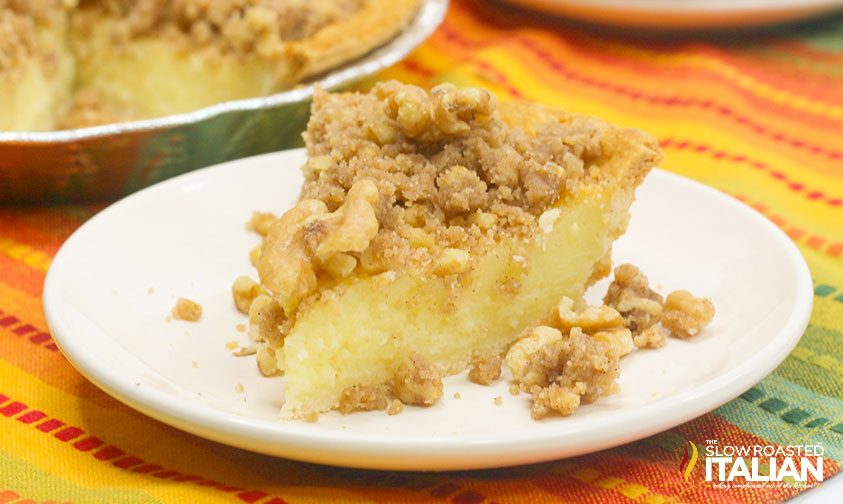slice of buttermilk pie with streusel topping on white plate