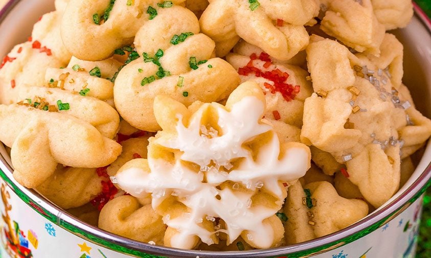 close up: holiday tin full of decorated spritz cookies