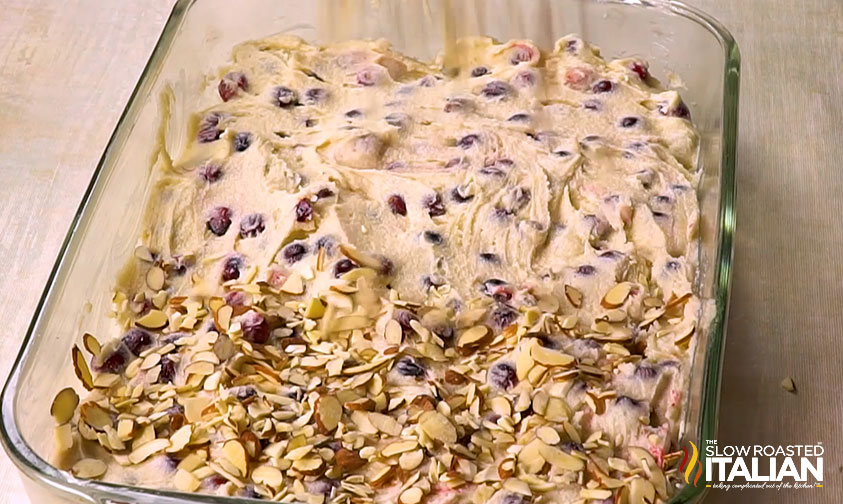 pouring batter for cranberry christmas cake into baking dish
