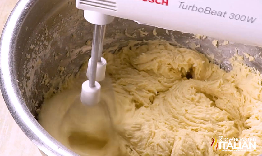 mixing batter for cranberry christmas cake