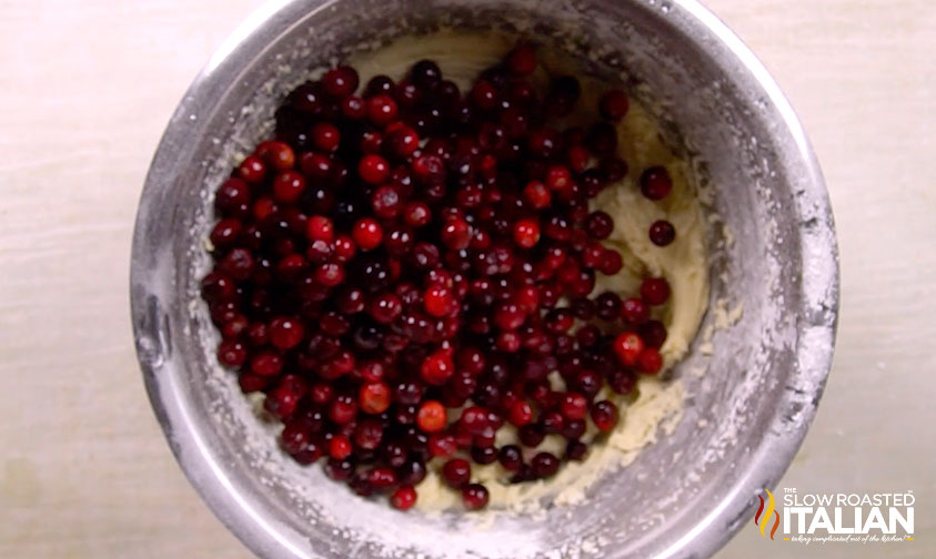 adding fresh cranberries to christmas cake batter