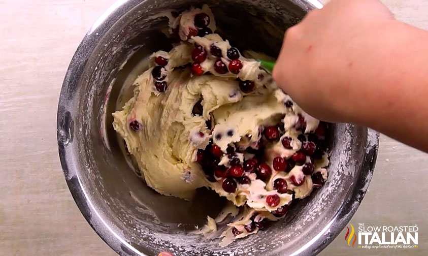 mixing fresh cranberries into cake batter