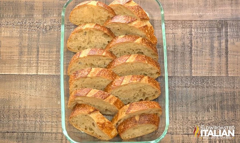 slices of french bread nestled into a baking dish