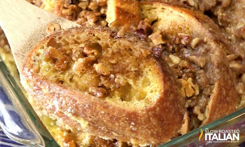 close up: serving slice of french toast from casserole