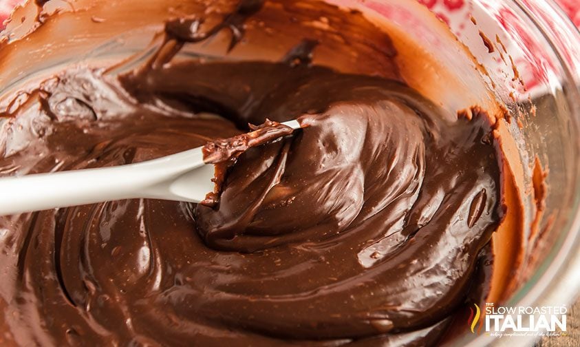 stirring melted chocolate mixture in bowl