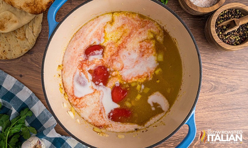 tomatoes, chicken stock and coconut milk added to pot