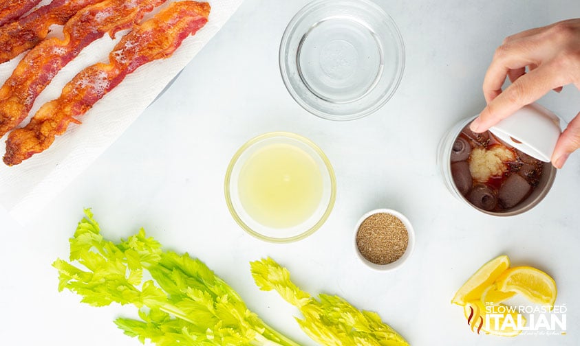 adding bloody mary ingredients to cocktail shaker