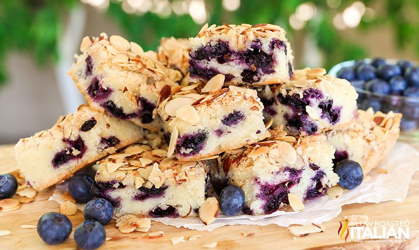 stacked slices of blueberry cake with almonds