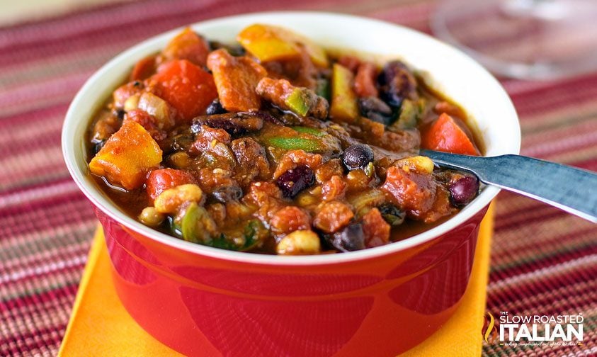 vegetarian chili in red bowl with spoon
