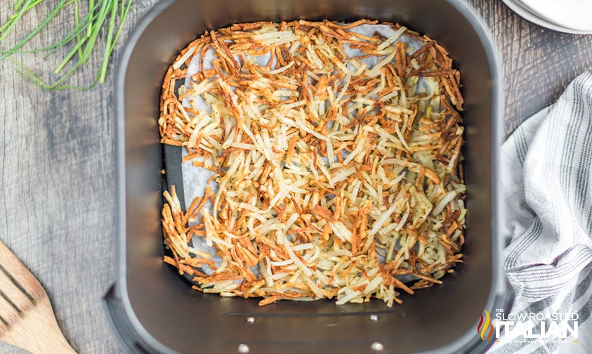 crispy hash browns in parchment lined air fryer basket