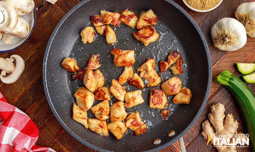 browning bite-sized chicken pieces in skillet