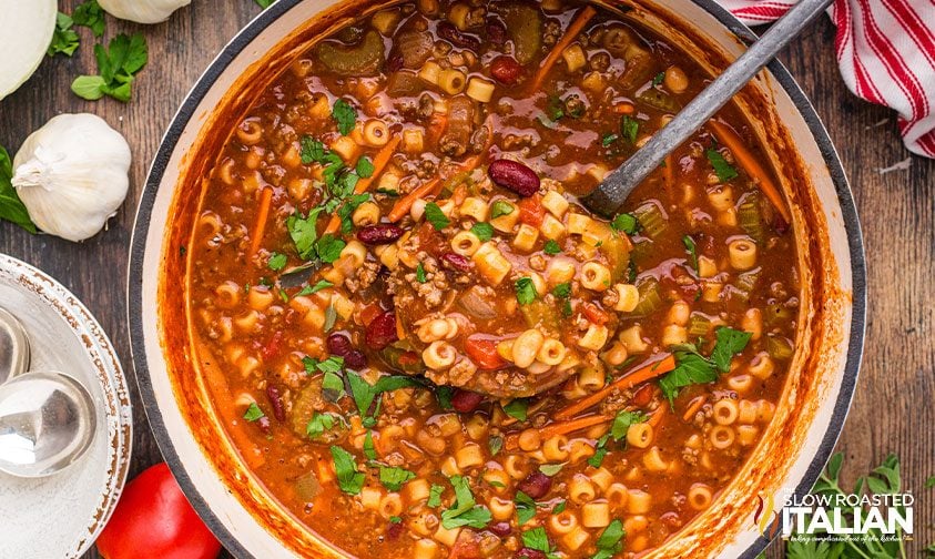 lifting ladle from pot of pasta e fagioli