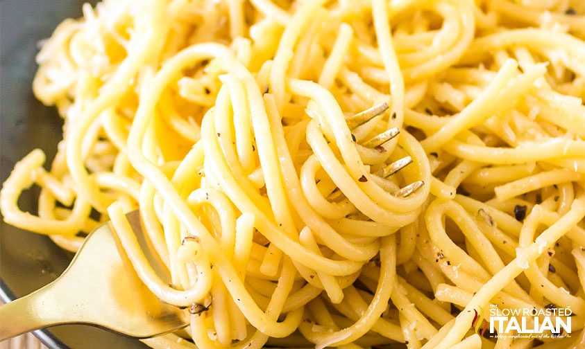 close up: cheesy pepper pasta twirled onto fork