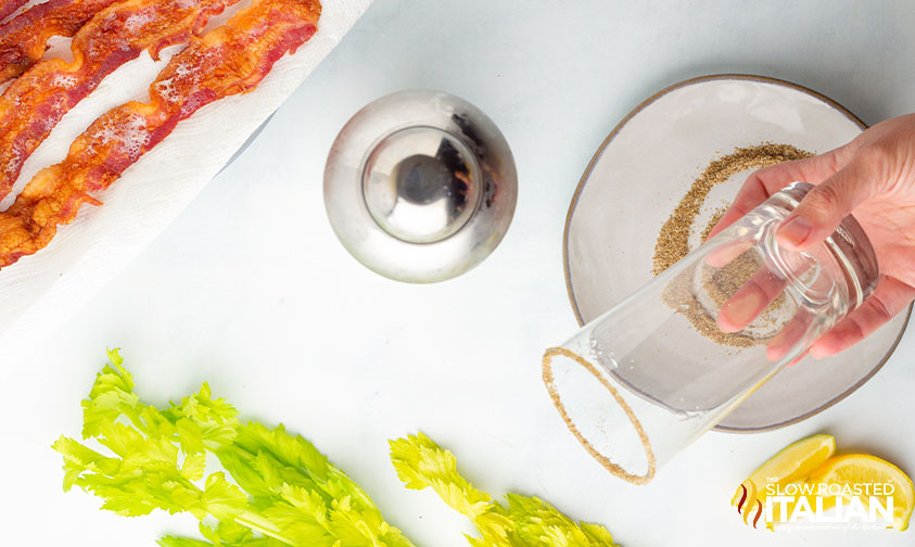 adding celery salt to rim of drinking glass