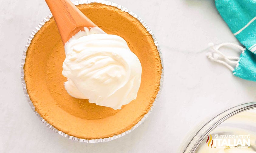 adding filling to pie crust