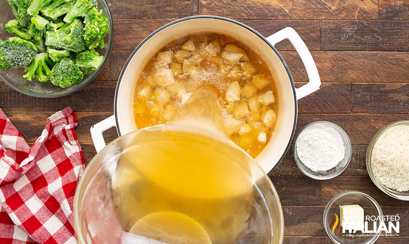 pouring stock into cooked chiken